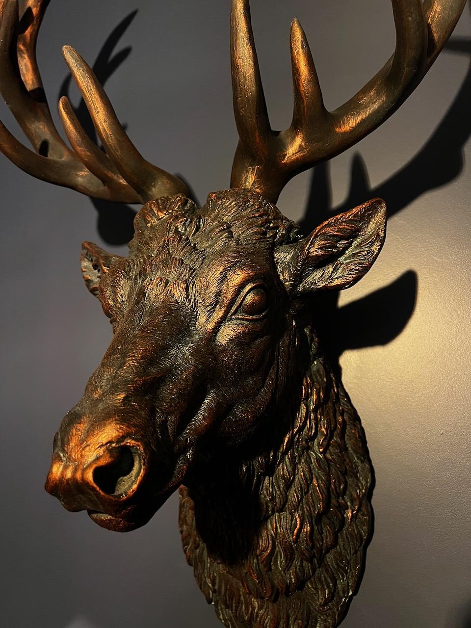 A bronze stag's head mounted on the wall